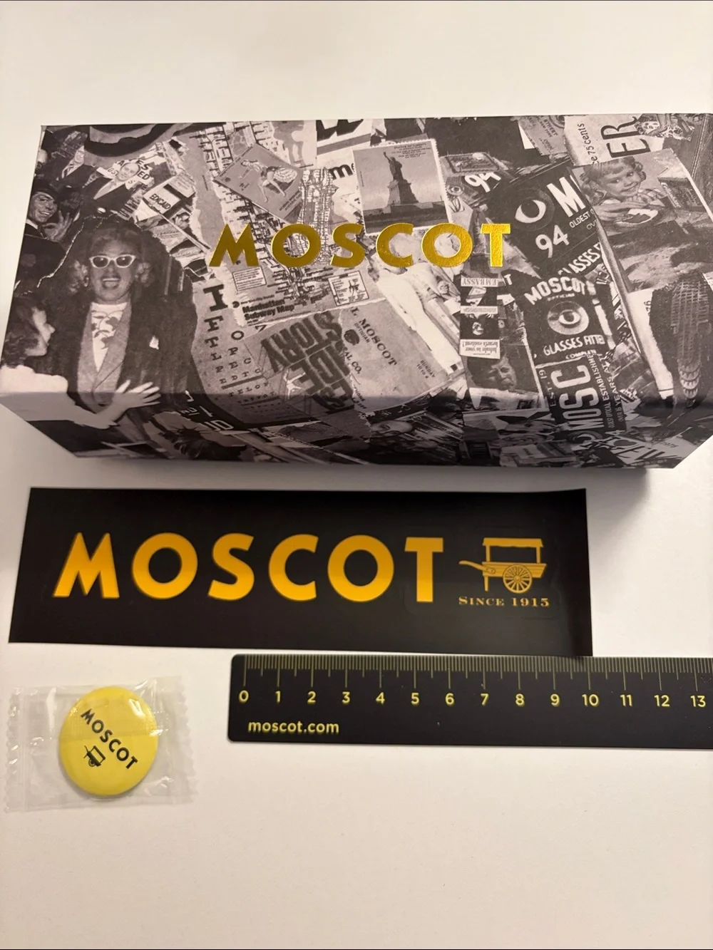 MOSCOT Yellow & Black Eyewear Box with Graphic, yellow Moscot pin and ruler